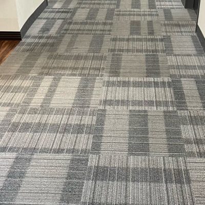 Hallway with clean geometric-patterned carpet in an office building.